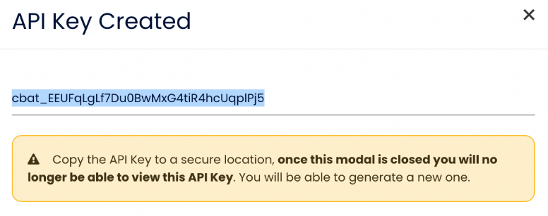 The API Key Created modal showing a cbat_ key value and a warning that it cannot be viewed again once the modal is closed.
